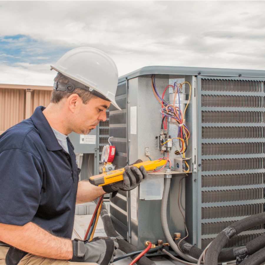 Pickering Heating & Cooling HVAC technician servicing a system